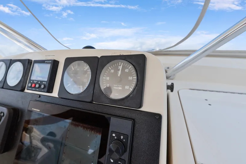 Slide: The Image of Dashboard of a 1995 Pursuit 3000 Offshore boat with gauges and controls. - 18
