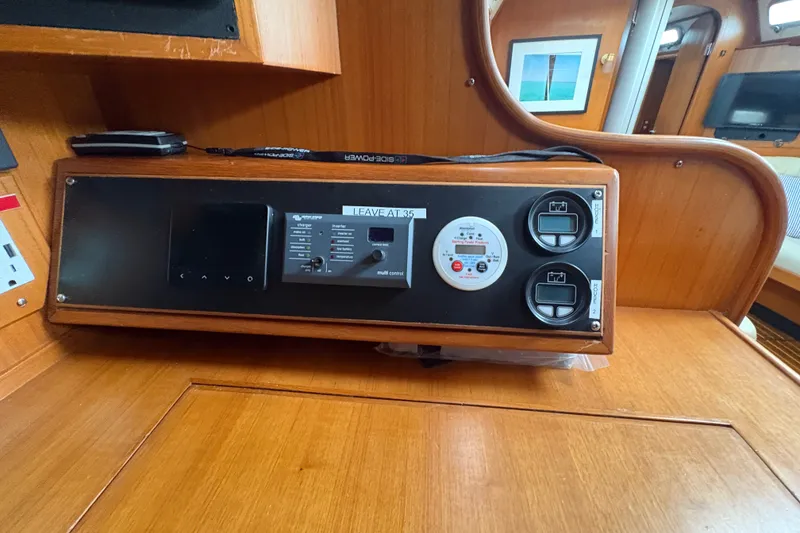 Slide: The Image of Control panel inside a 1998 Hylas 46 yacht, featuring various gauges and switches. - 20