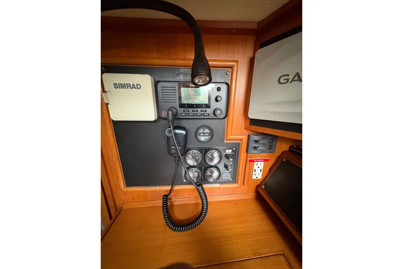 Slide: The Image of Navigation equipment panel on a 1998 Hylas 46 yacht, featuring Simrad and Garmin devices. - 18