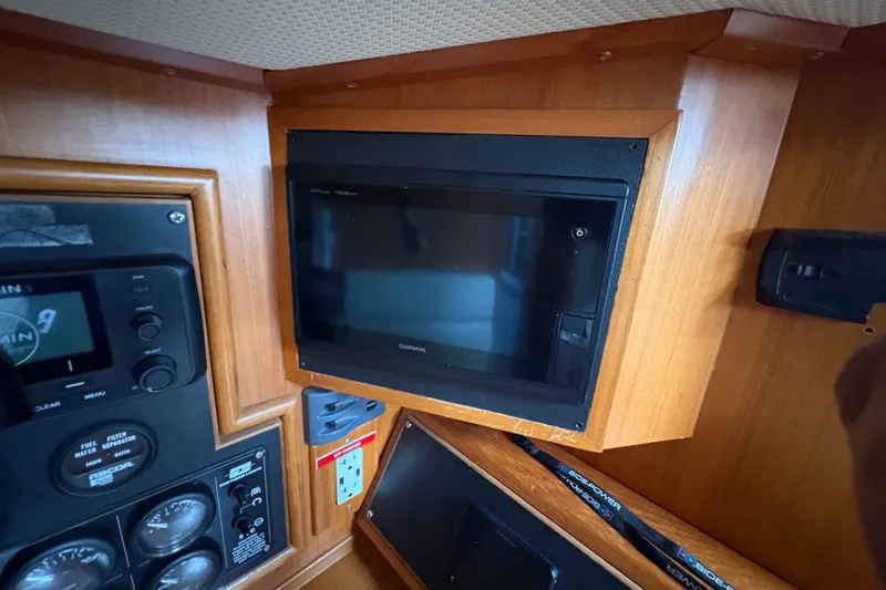 Slide: The Image of Garmin GPS system in 1998 Hylas 46 yacht interior with wooden paneling. - 21