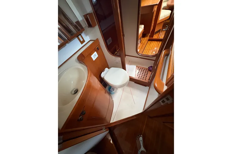 Slide: The Image of Interior of 1998 Hylas 46 yacht bathroom with sink, toilet, and wooden accents. - 15