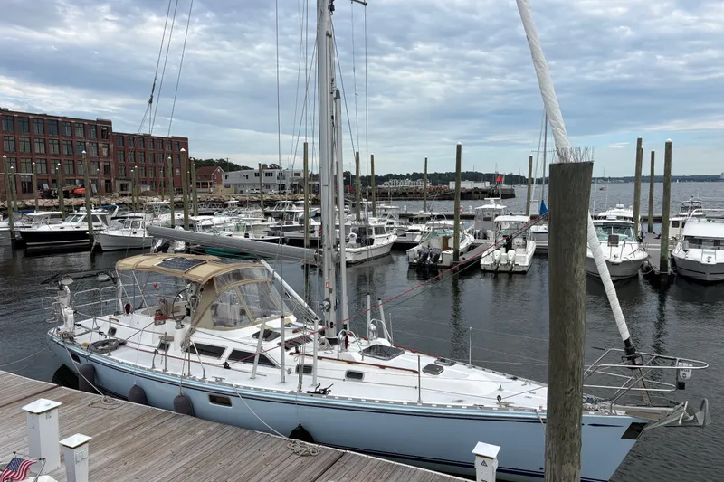 The Image of Sailboat docked at marina, Hylas 46 model, 1998, with overcast sky. - 1