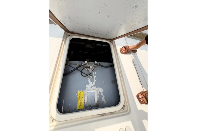Slide: The Image of Open hatch on 1974 Bertram 31 Flybridge Cruiser, revealing interior components. - 35