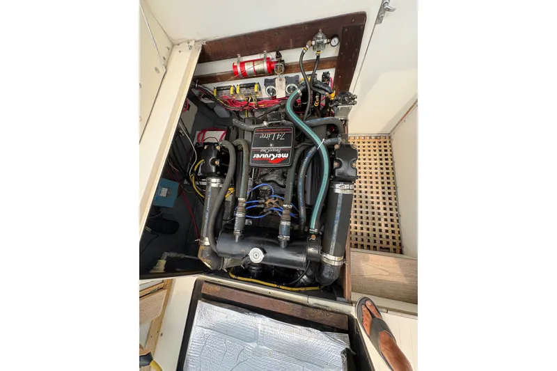 Slide: The Image of Engine compartment of a 1974 Bertram 31 Flybridge Cruiser with visible wiring and components. - 38
