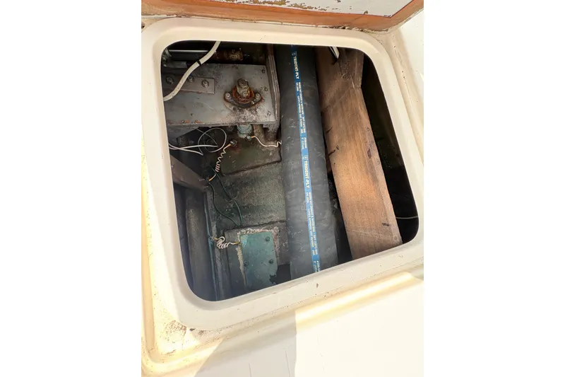 Slide: The Image of Engine compartment of a 1974 Bertram 31 Flybridge Cruiser, showing mechanical components and wiring. - 33