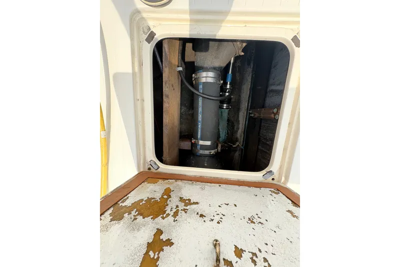 Slide: The Image of 1974 Bertram 31 Flybridge Cruiser engine compartment with visible mechanical components. - 37