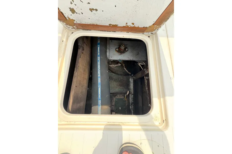 Slide: The Image of Open hatch on 1974 Bertram 31 Flybridge Cruiser, revealing interior components. - 36