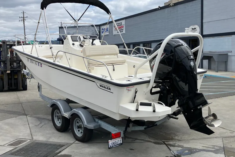Slide: The Image of 2023 Boston Whaler 190 Montauk boat on trailer, parked outdoors. - 14