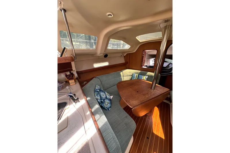 Slide: The Image of Interior of 1997 Hunter 34 sailboat with cozy seating and wooden table. - 28