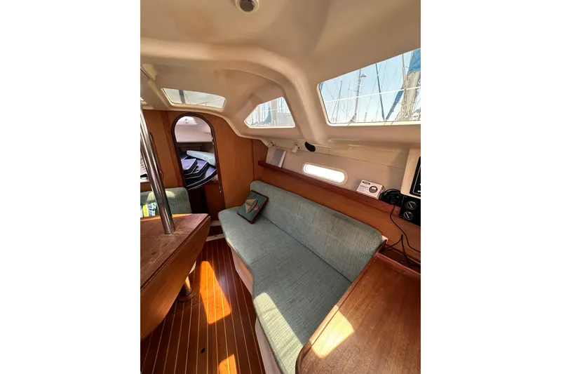 Slide: The Image of Interior of a 1997 Hunter 34 sailboat with cozy seating and wooden accents. - 29