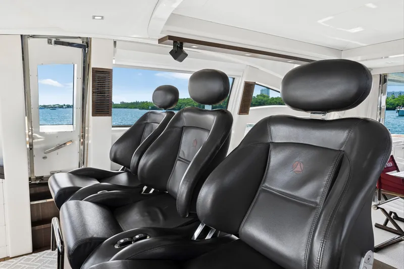 Slide: The Image of Luxurious black leather seats on a 2009 Azimut 86S yacht with scenic ocean view. - 87