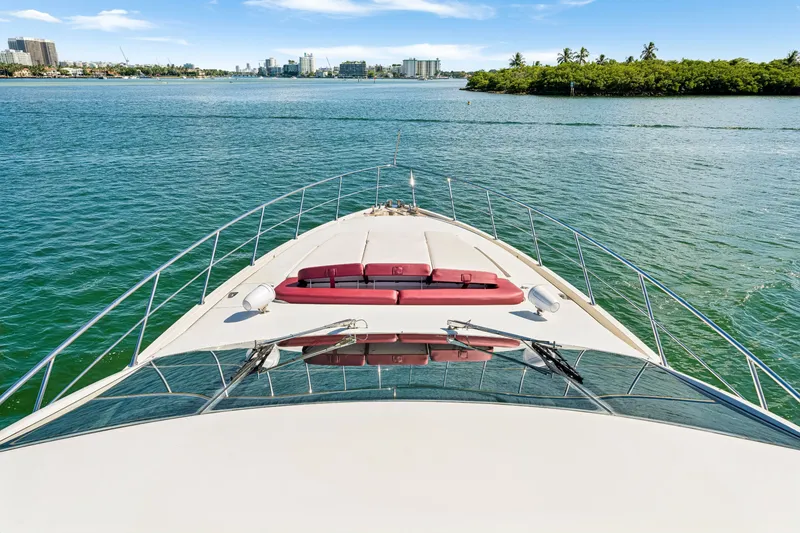 Slide: The Image of 2009 Azimut 86S yacht cruising on a serene waterway with cityscape in the background. - 70