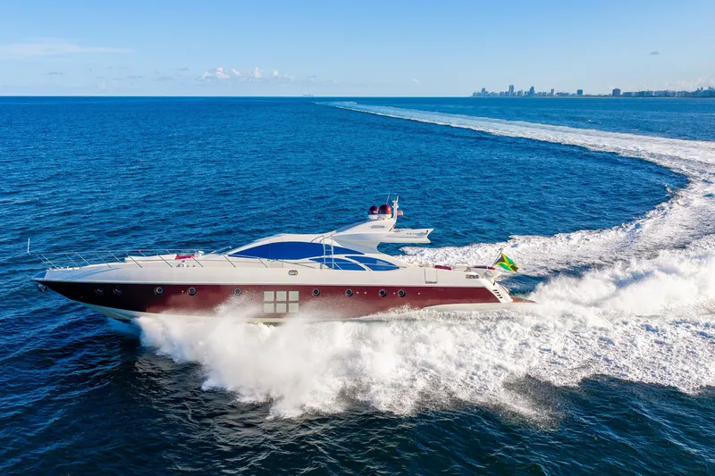 Slide: The Image of Luxury 2009 Azimut 86S yacht cruising on open ocean with city skyline in background. - 35
