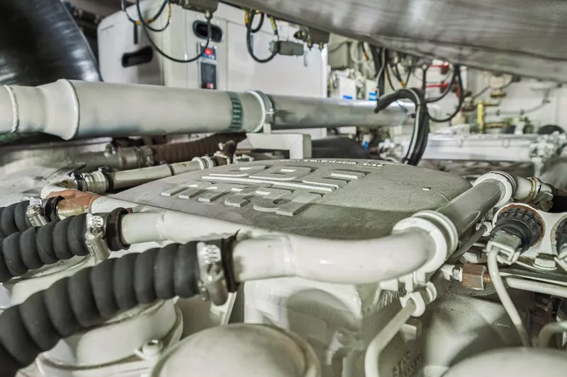 Slide: The Image of Engine room of a 2009 Azimut 86S yacht, showcasing mechanical components and piping. - 119