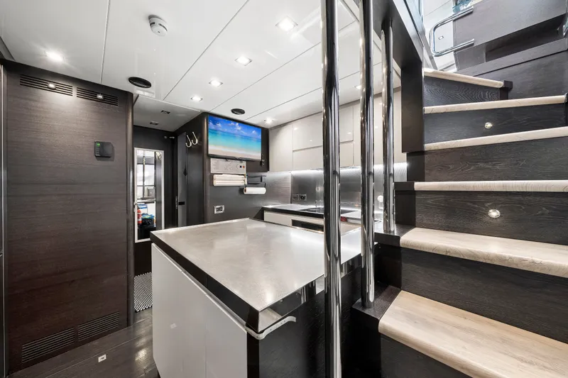 Slide: The Image of Luxurious interior of a 2009 Azimut 86S yacht featuring modern kitchen and staircase. - 112