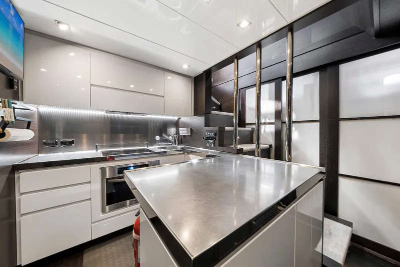 Slide: The Image of Modern kitchen interior on 2009 Azimut 86S yacht, featuring sleek stainless steel surfaces. - 113