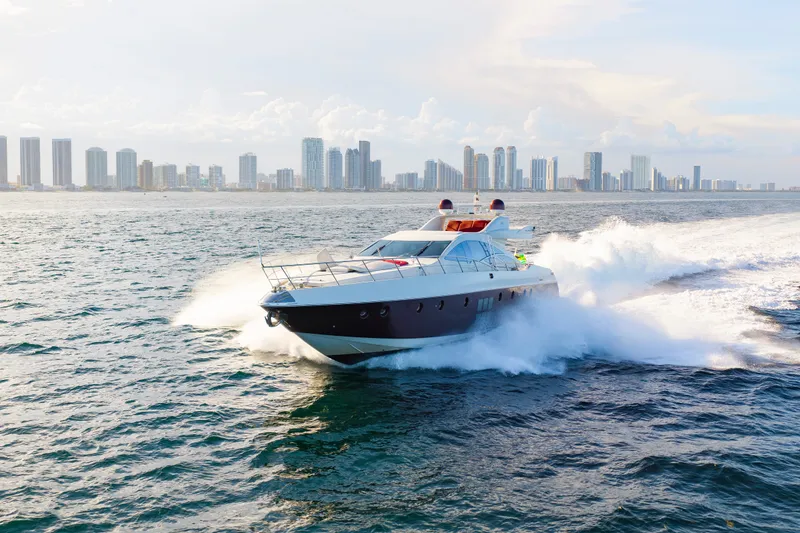 Slide: The Image of 2009 Azimut 86S yacht cruising near city skyline on open water. - 44