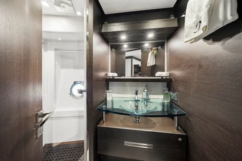 Slide: The Image of Luxurious bathroom interior of 2009 Azimut 86S yacht with modern glass sink and wooden accents. - 108