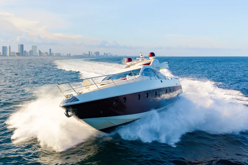 Slide: The Image of Luxurious 2009 Azimut 86S yacht cruising swiftly on open ocean near city skyline. - 46