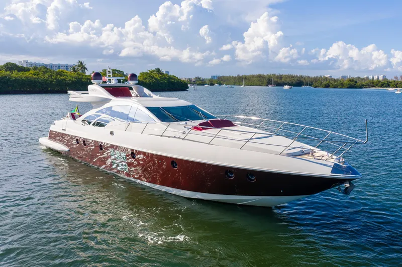 Slide: The Image of Luxurious 2009 Azimut 86S yacht cruising on a serene waterway under a clear sky. - 24