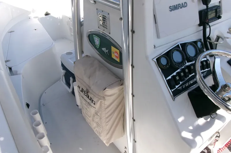 Slide: The Image of 2008 Triumph 235 CC boat interior with steering wheel and control panel. - 9