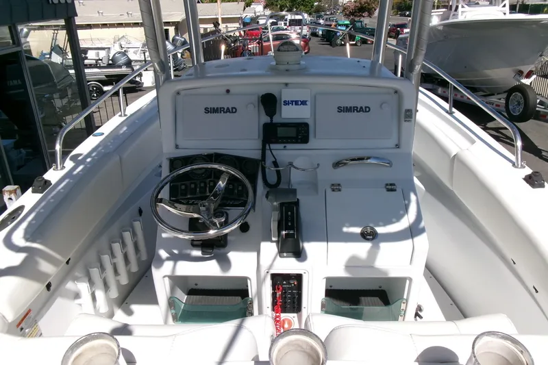 Slide: The Image of 2008 Triumph 235 CC boat cockpit with steering wheel and navigation equipment. - 12