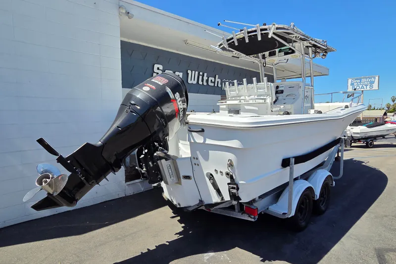 Slide: The Image of 2008 Triumph 235 CC boat with Suzuki outboard motor on trailer. - 2