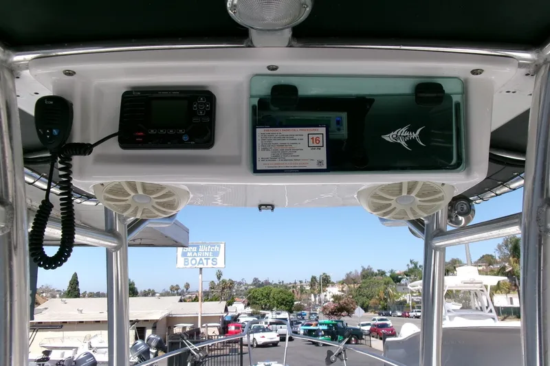 Slide: The Image of 2008 Triumph 235 CC boat console with radio and speakers, Sea Witch Marine Boats sign visible. - 14