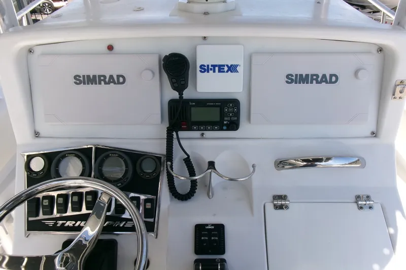 Slide: The Image of Console of a 2008 Triumph 235 CC boat with Simrad electronics and steering wheel. - 13