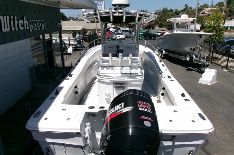 Slide: The Image of 2008 Triumph 235 CC boat with Suzuki 250 engine at a marine dealership. - 32