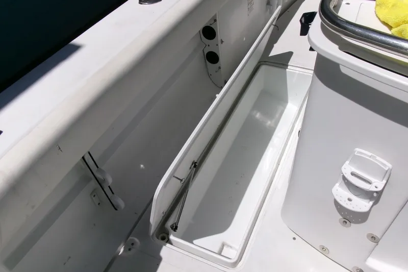 Slide: The Image of 2008 Triumph 235 CC boat interior storage compartment, open and empty. - 27