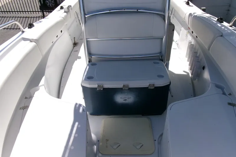 Slide: The Image of 2008 Triumph 235 CC boat interior with cooler and seating area. - 8