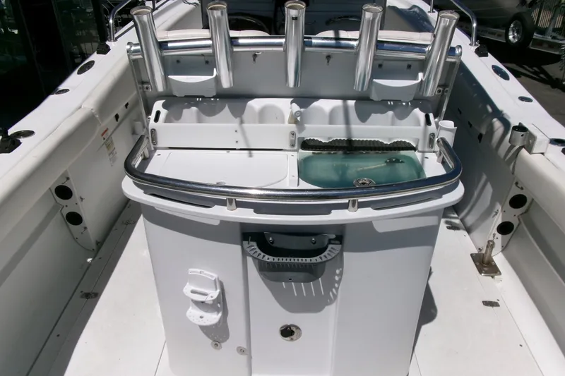 Slide: The Image of 2008 Triumph 235 CC boat interior with fishing rod holders and storage compartments. - 17