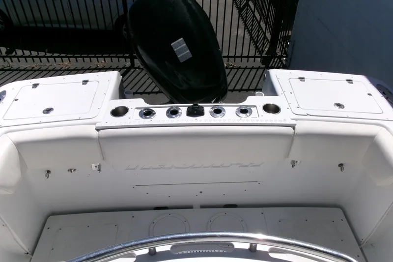 Slide: The Image of 2008 Triumph 235 CC boat interior with storage compartments and rod holders. - 22