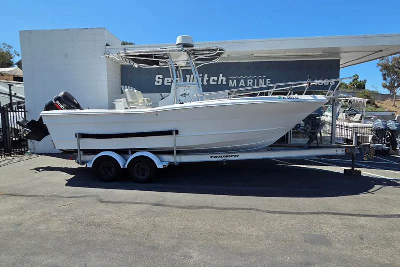 Slide: The Image of 2008 Triumph 235 CC boat on trailer at dealership, side view. - 0