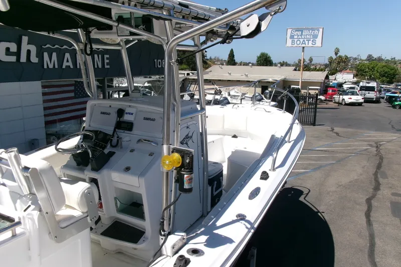 Slide: The Image of 2008 Triumph 235 CC boat at Sea Witch Marine dealership, featuring a sleek white design. - 30