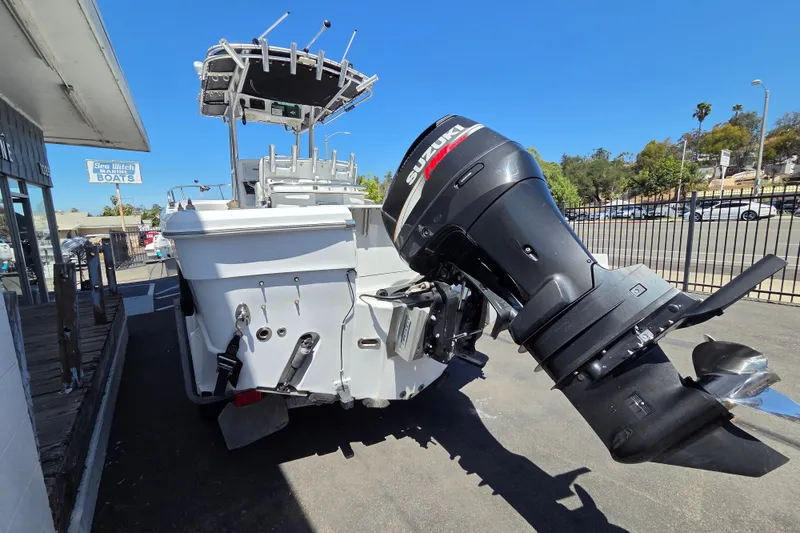 Slide: The Image of 2008 Triumph 235 CC boat with Suzuki outboard motor, parked outdoors. - 3