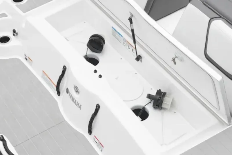 Slide: The Image of 2026 Yamaha Boats SX250 interior with storage compartment and seating area. - 6
