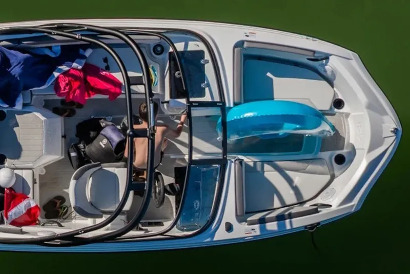 Slide: The Image of Overhead view of 2027 Yamaha Boats AR182 on water, featuring passengers and colorful gear. - 4