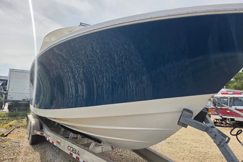 Slide: The Image of 2018 Regulator 34 Center Console boat on trailer, blue hull, outdoor setting. - 62