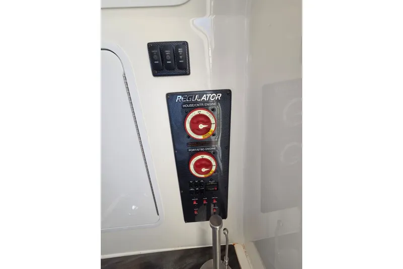 Slide: The Image of Control panel of 2018 Regulator 34 Center Console boat with engine switches. - 21