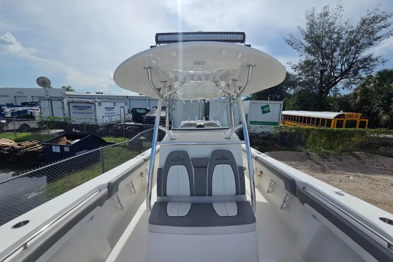 Slide: The Image of 2018 Regulator 34 Center Console boat with seating and T-top in a yard setting. - 13