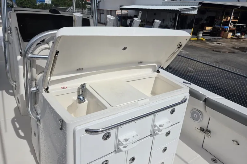 Slide: The Image of 2018 Regulator 34 Center Console boat with open sink and storage compartments. - 37