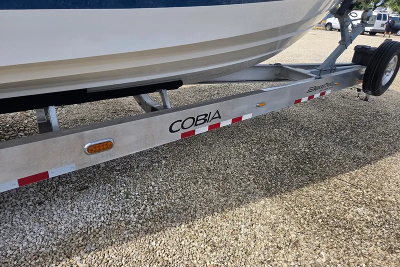 Slide: The Image of 2018 Regulator 34 Center Console on Cobia trailer, parked on gravel. - 56