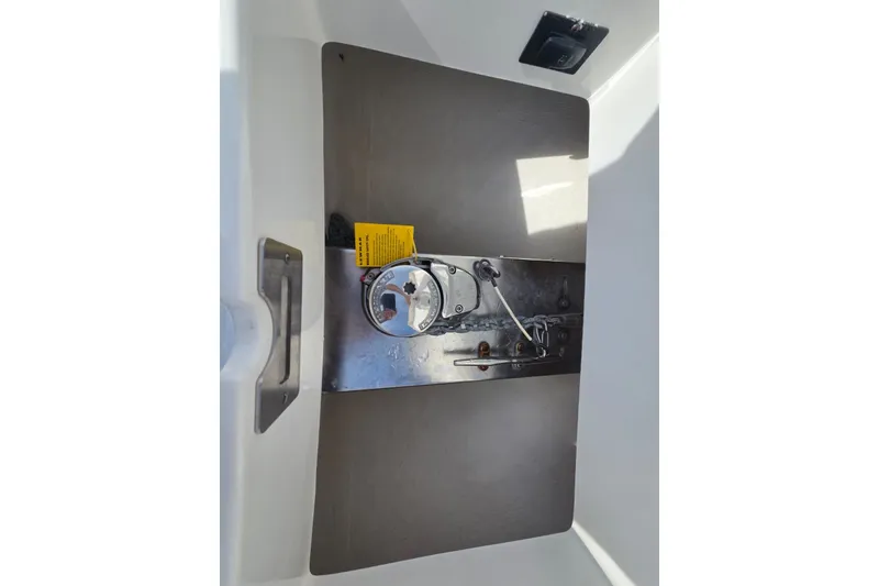 Slide: The Image of 2018 Regulator 34 Center Console boat compartment with control panel and handle. - 25