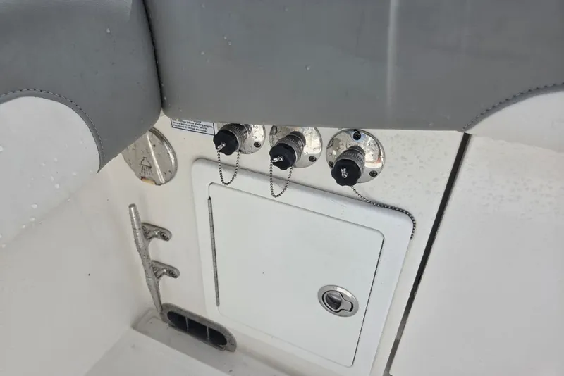Slide: The Image of 2018 Regulator 34 Center Console boat controls and storage compartment. - 29