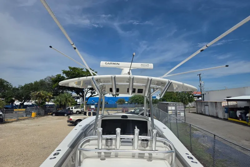 Slide: The Image of 2018 Regulator 34 Center Console boat with Garmin radar, parked outdoors. - 34
