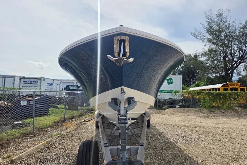 Slide: The Image of 2018 Regulator 34 Center Console boat on trailer, parked in a gravel lot. - 60