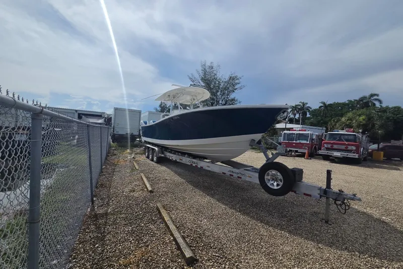 Slide: The Image of 2018 Regulator 34 Center Console boat on trailer in outdoor storage area. - 38