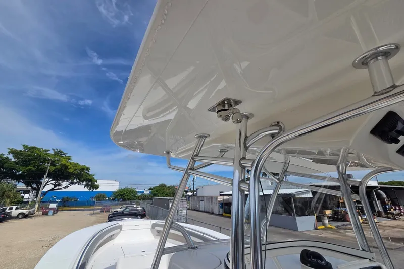 Slide: The Image of 2018 Regulator 34 Center Console boat with T-top and stainless steel supports. - 28